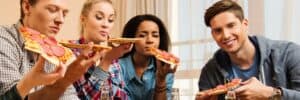 Group-of-friends-eating-pizza-takeaway