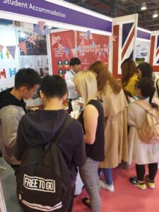 students at host stand China Education Expo CEE